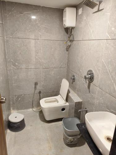 a bathroom with a toilet and a sink at Hotel Palak Palacce in Ahmedabad