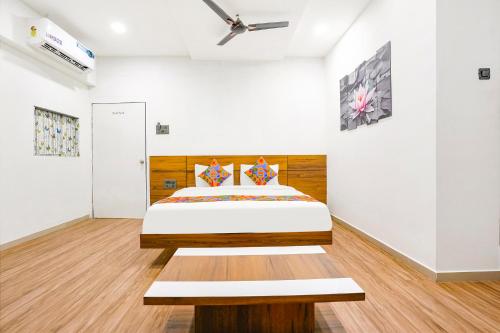 um quarto com uma cama e uma cabeceira em madeira em FabHotel 7 Star em Surate