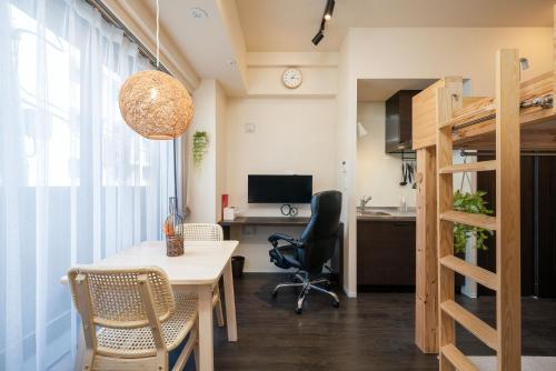 an office with a desk and a table and chairs at Home Sweet Office Kamata in Tokyo