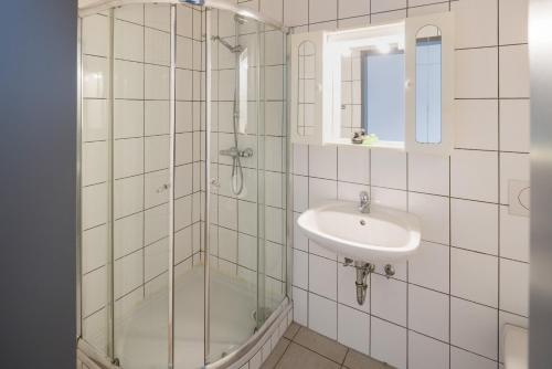 een badkamer met een glazen douche en een wastafel bij Workers Apartment für die besten Monteure in Leoben und Bruck an der Mur in Oberaich