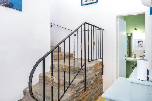 a staircase in a home with black railings at Blue and White in Otziás