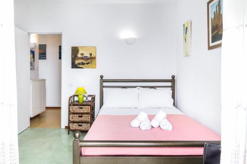 a bedroom with a bed with two slippers on it at Blue and White in Otzias