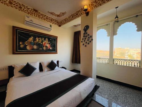 a bedroom with a bed with a picture of fruit on the wall at Teerth Palace Pushkar in Pushkar