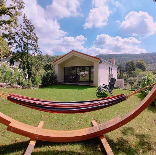 a large hammock in the yard of a house at Gaja & Sara Apartments in Kozina