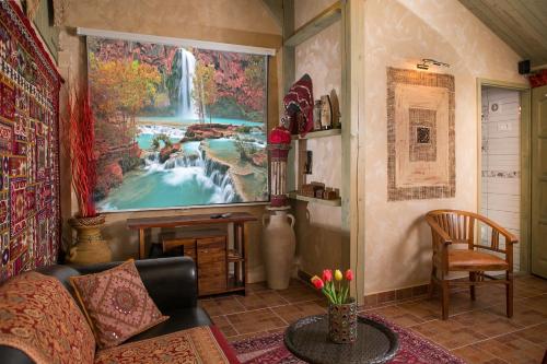 a living room with a large painting of a waterfall at Green Park Villa in Eger
