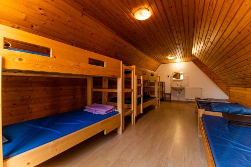 a room with three bunk beds in a cabin at LÁSZLÓ Turistaszálló in Visegrád