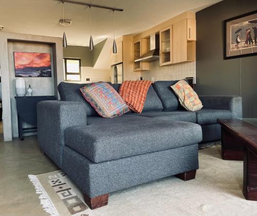 a living room with a blue couch and a table at Ietzie Longbeach in Swakopmund