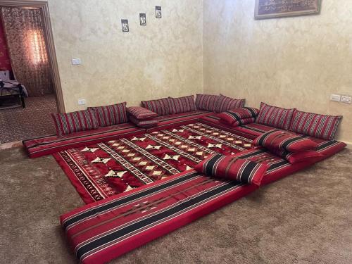 a couch made out of wine bottles in a living room at Nabatean NIghts Home Stay in Wadi Musa