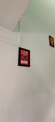 a sign is hanging on a white wall at Siddhi Sea View Bungalow Ganpatipule for Family in Ratnagiri