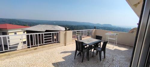 a patio with a table and chairs on a balcony at Siddhi Sea View Bungalow Ganpatipule for Family in Ratnagiri