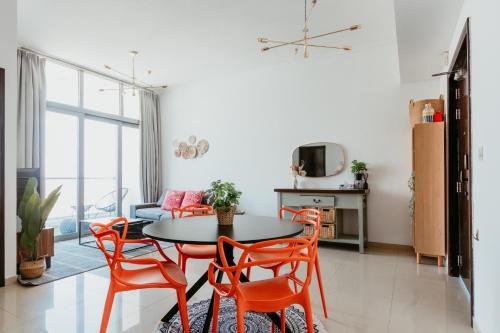 a living room with a table and chairs at Cozy 1 BR in Dubai Marina in Dubai