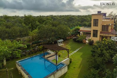 an aerial view of a house and a swimming pool at Ekostay Gold - Olive Crest Villa - Spacious Lawn in Lonavala
