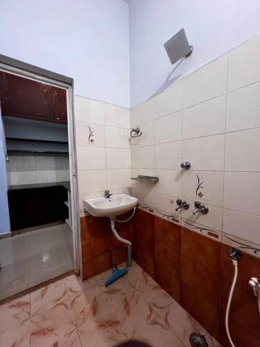 a bathroom with a sink and a shower at MOA Auroville pondicherry in Auroville