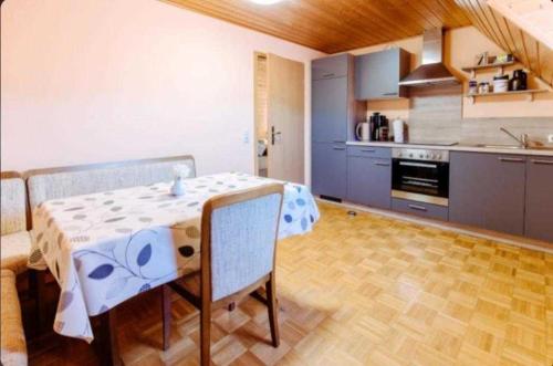 a kitchen with a table and chairs in a room at Ferienwohnung Erlwein 