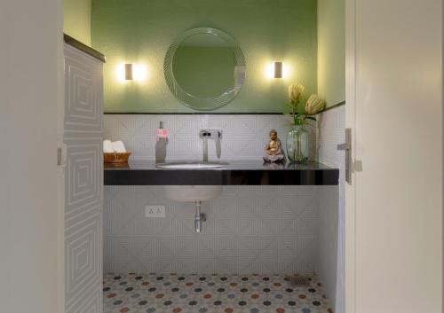 a bathroom with a sink and a mirror at Jaipur Bungalow in Jaipur