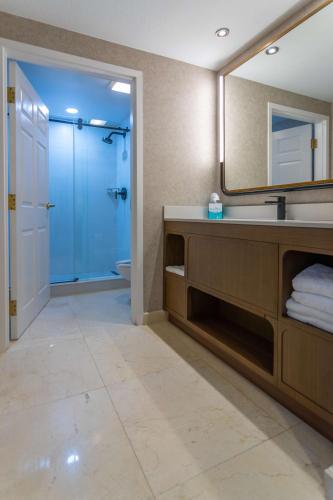 a bathroom with a sink and a mirror at Hotel Flor Tampa Downtown, Tapestry Collection By Hilton in Tampa