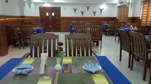 a dining room with a table with a blue table cloth at Kallada Mamatha Motels in Kunnamkulam