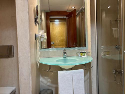 a bathroom with a sink and a mirror at Gran Hotel Liber & Spa Playa Golf in Noja
