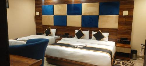 Ένα ή περισσότερα κρεβάτια σε δωμάτιο στο Poddar Residency