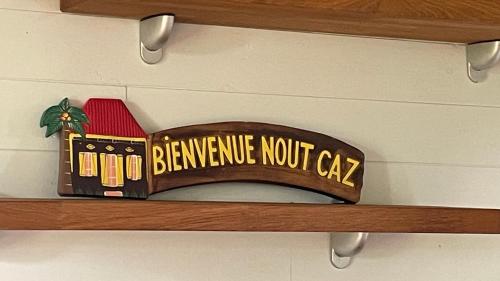 a wooden shelf with a sign that says bernine north cap at La Petite Kaz Dans la Savane in Fleurimont