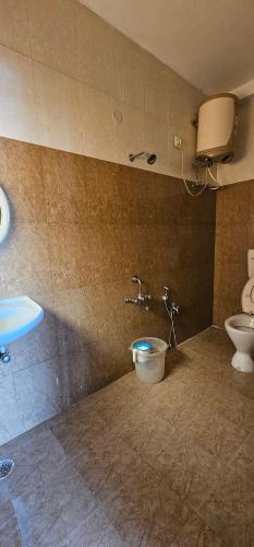 uma casa de banho com um WC e um lavatório em OOTY STAY AWHILE em Ooty