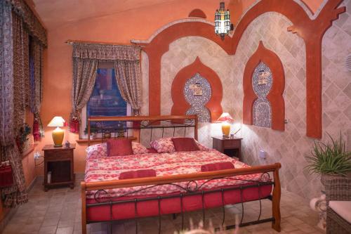 a bedroom with a bed and two lamps in it at Green Park Villa in Eger