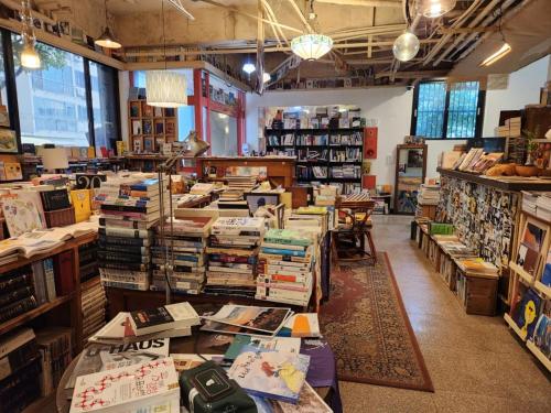 a book store filled with lots of books on tables at Book Hotel in Jeju