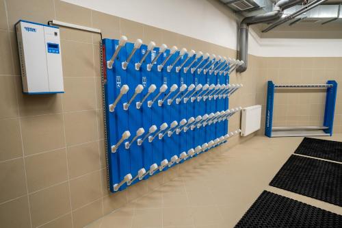 a locker room with blue doors and white handles at Spa & Wellness Hotel Fitak**** in Liptovský Ján