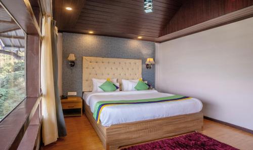 Postel nebo postele na pokoji v ubytování Treebo Eeshan Rodhi Resort, Darjeeling