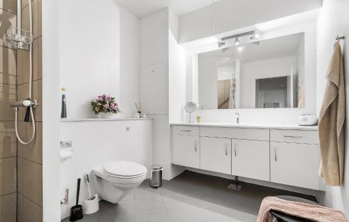 a white bathroom with a toilet and a sink at 2 Bedroom Nice Apartment In Fan in Fanø
