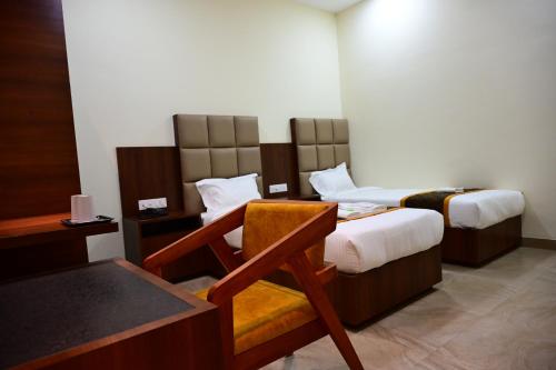 Ένα ή περισσότερα κρεβάτια σε δωμάτιο στο Unnati Stay Inn Vijayapura