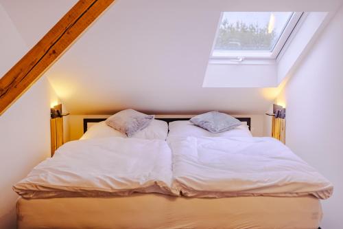 a bed in a room with a window at Rezidence Petra Voka in Třeboň