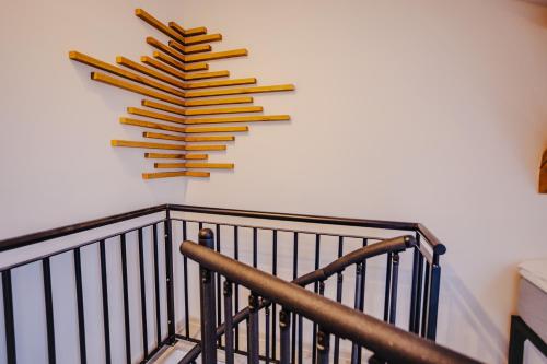a bunch of wooden sticks hanging on a wall at Rezidence Petra Voka in Třeboň