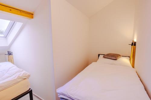 a small bedroom with a bed and a window at Rezidence Petra Voka in Třeboň