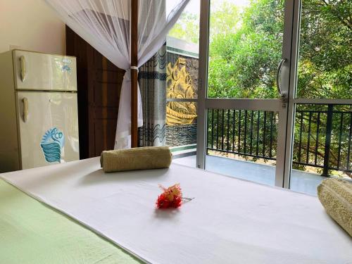 a room with a white table with a view of a window at Era Holiday House in Mirissa