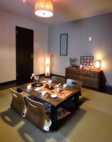 a dining room with a table and chairs and a bed at NEW-130m2 with 5toilets & 4 showers-Namba and USJ nearby in Osaka