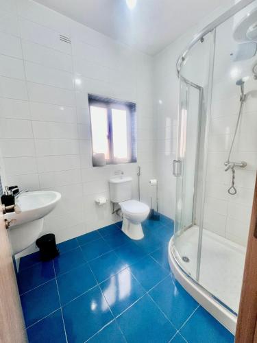 a bathroom with a toilet and a sink and a shower at 83/3-Lovely 1 Bedroom Penthouse in Birkirkara