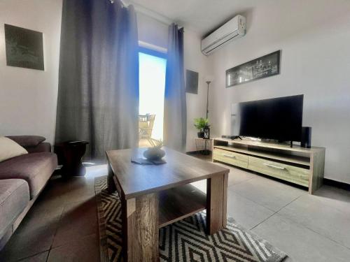 a living room with a couch and a television at 83/3-Lovely 1 Bedroom Penthouse in Birkirkara