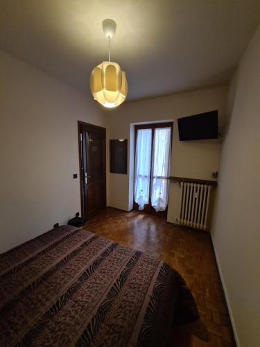 a bedroom with a large bed and a light at La Dolce Vita, appartamento al centro di Biella in Biella