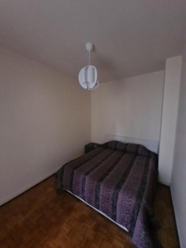 a bedroom with a bed in a white room at La Dolce Vita, appartamento al centro di Biella in Biella