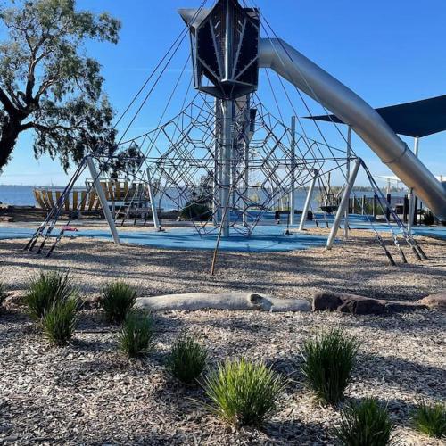 a playground with a slide in a park at The Sturt Stay in Mulwala