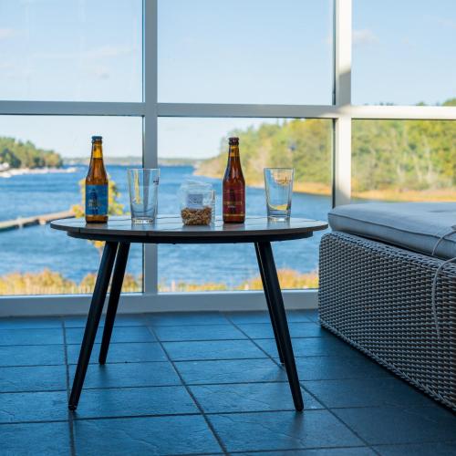 a table with three bottles and glasses on it at Skeviks Gård in Gustavsberg