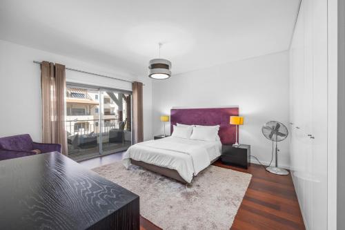 a bedroom with a bed and a living room at Pine Garden Apartment Vilamoura in Vilamoura