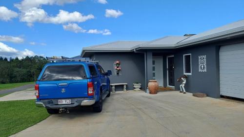 a blue truck parked in front of a house at Cozy Room with Separate Entrance and Ensuit Bathroom in Atherton