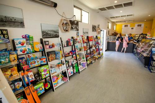 a store with children standing in the aisle at Tāhuna Beach Holiday Park in Nelson