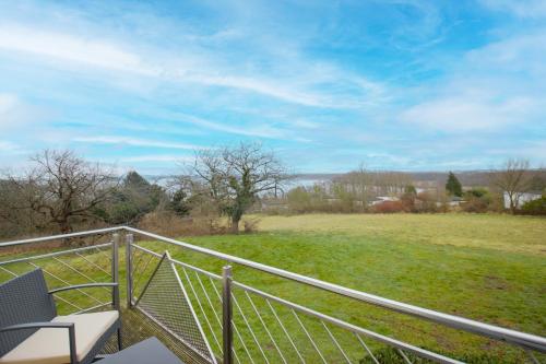 a balcony with a view of a field at Inselhotel kleiner Bodden in Buschvitz