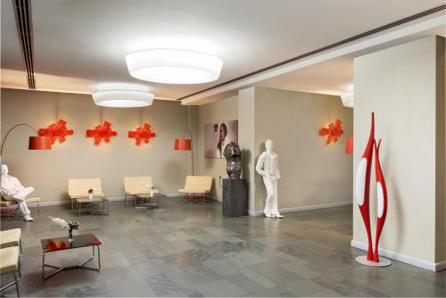 a room with chairs and a mannequin on the wall at Hotel Golden Tulip Ana Tower Sibiu in Sibiu