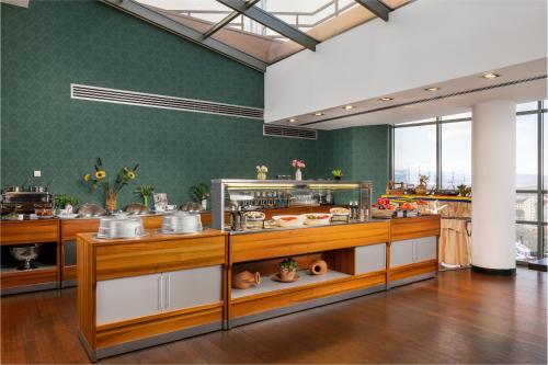 a large kitchen with a lot of food on display at Hotel Golden Tulip Ana Tower Sibiu in Sibiu