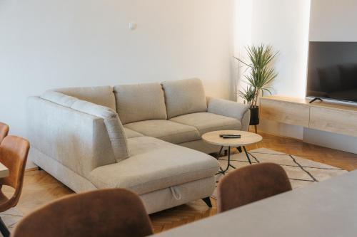 a living room with a couch and a table at Silencia in Osijek