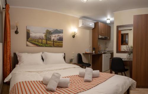 a bedroom with a bed with two towels on it at Voulas Traditional House Meteora 3 in Kalabaka